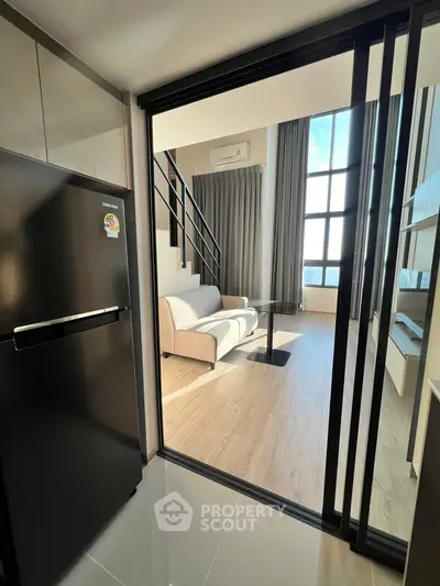 Modern loft apartment with high ceilings and sleek design, featuring a cozy living area and stylish kitchen.