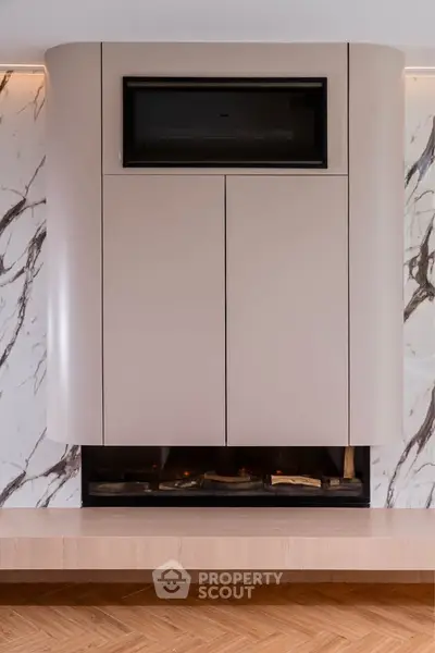 Luxurious modern fireplace with sleek marble backdrop and elegant wood flooring, perfect for upscale living rooms.
