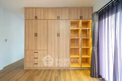 Spacious bedroom with elegant wooden wardrobe and natural light