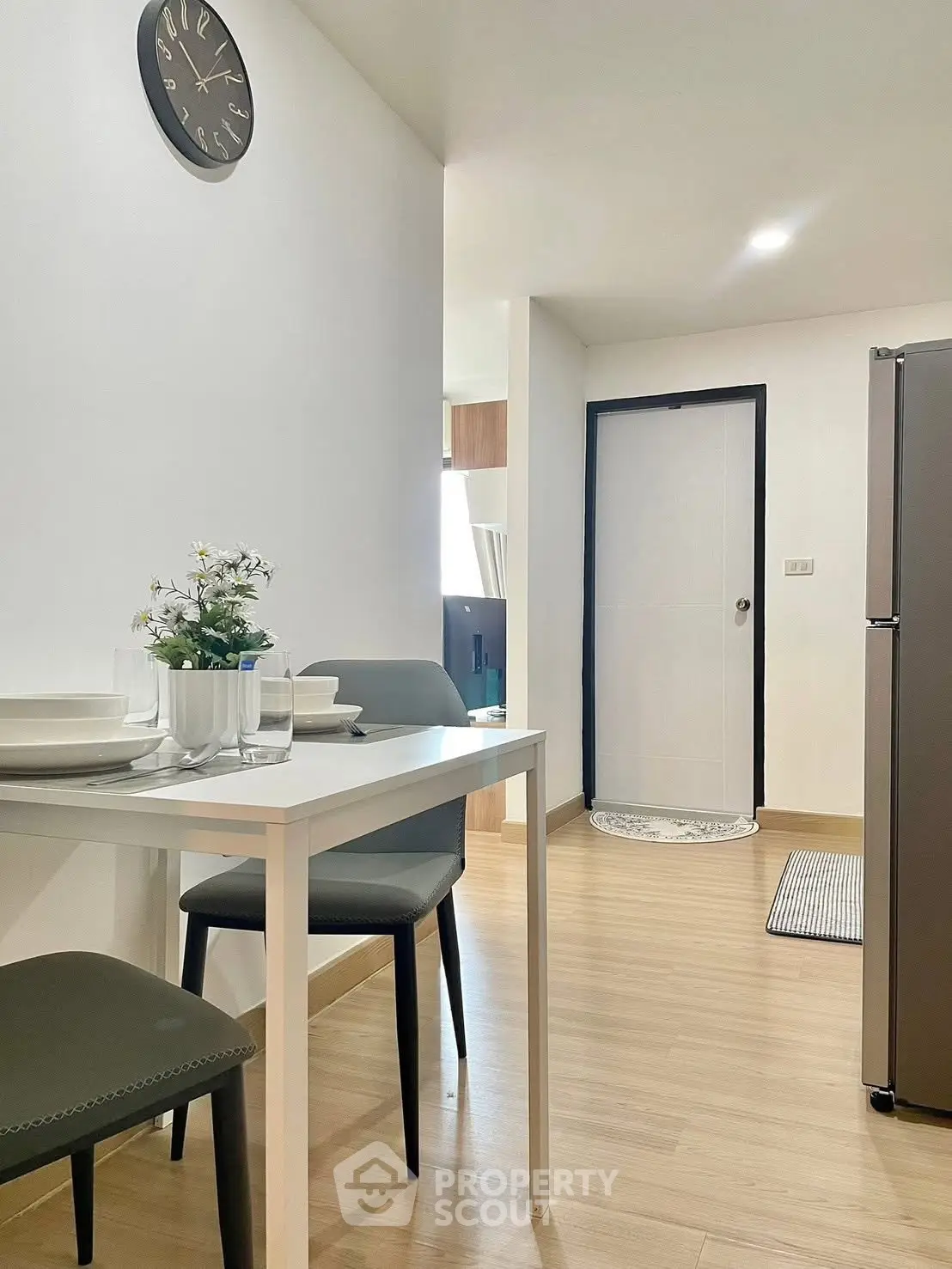 Modern apartment interior with dining area and sleek kitchen appliances