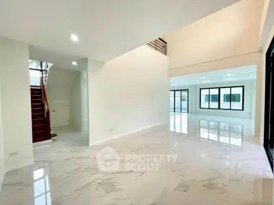 Spacious modern living room with marble flooring and large windows