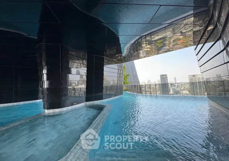 Stunning rooftop infinity pool with panoramic city views in luxury high-rise building.