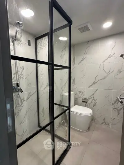 Modern bathroom with sleek glass shower and marble tiles