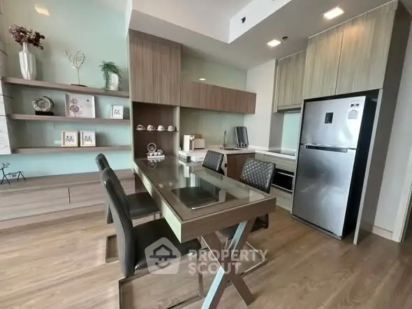Modern kitchen with sleek dining area and stainless steel appliances