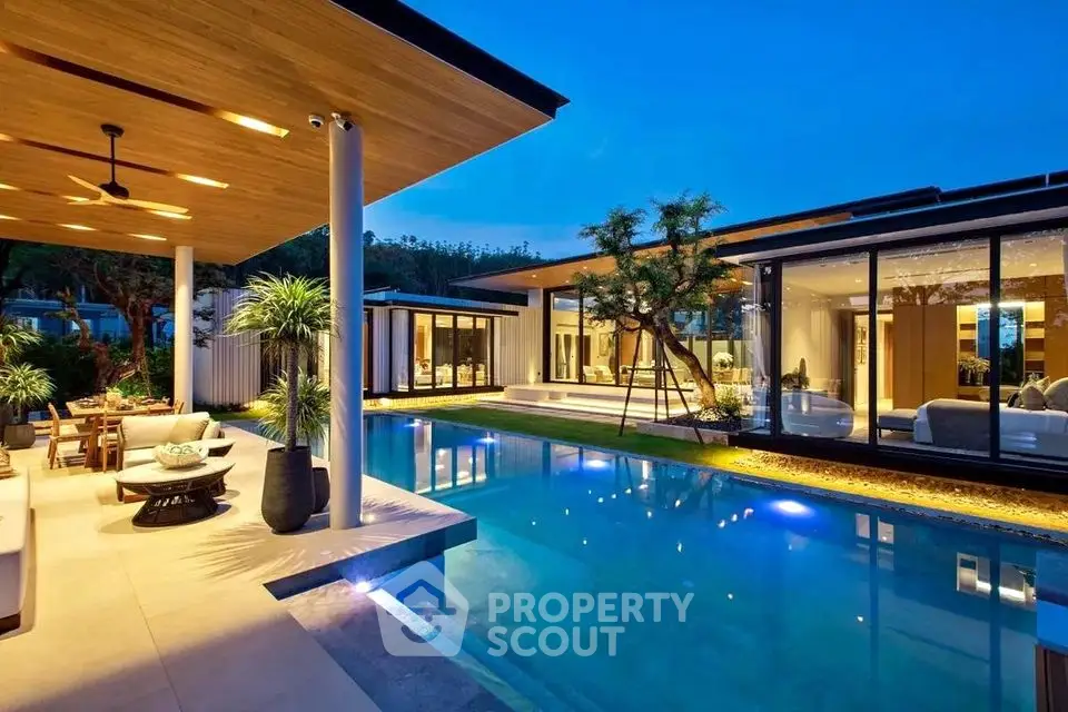Luxurious modern villa with stunning pool and elegant outdoor living space at dusk.