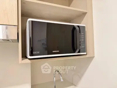 Modern kitchen with built-in microwave and sleek cabinetry