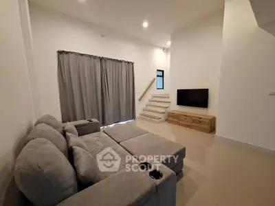 Spacious modern living room with cozy sectional sofa and wall-mounted TV