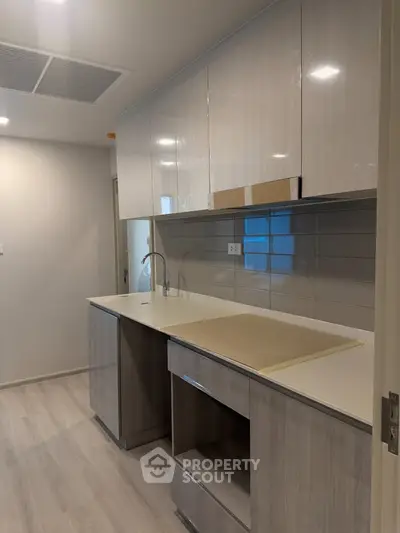 Modern kitchen with sleek cabinetry and neutral tones, perfect for contemporary living.