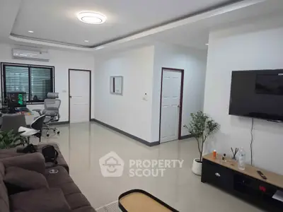 Modern living room with sleek design and home office setup