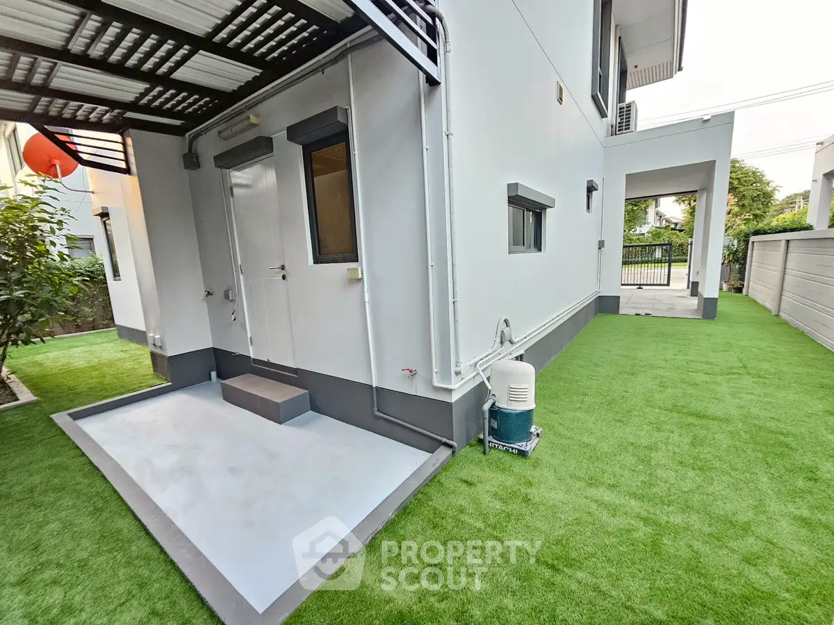 Modern exterior with artificial grass and sleek design