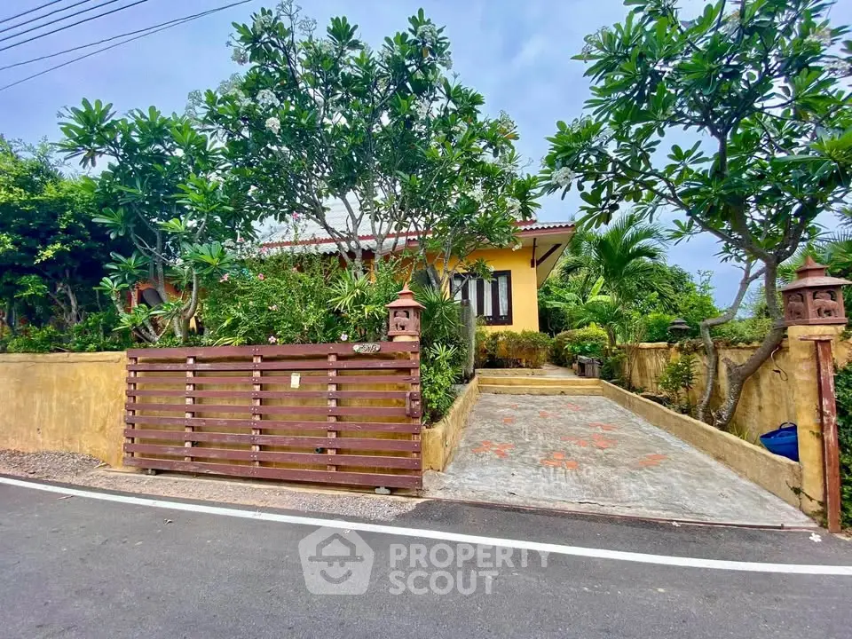 Charming tropical home with lush garden and inviting entrance, perfect for serene living.