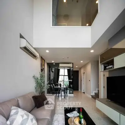 Spacious modern living room with high ceiling and elegant decor