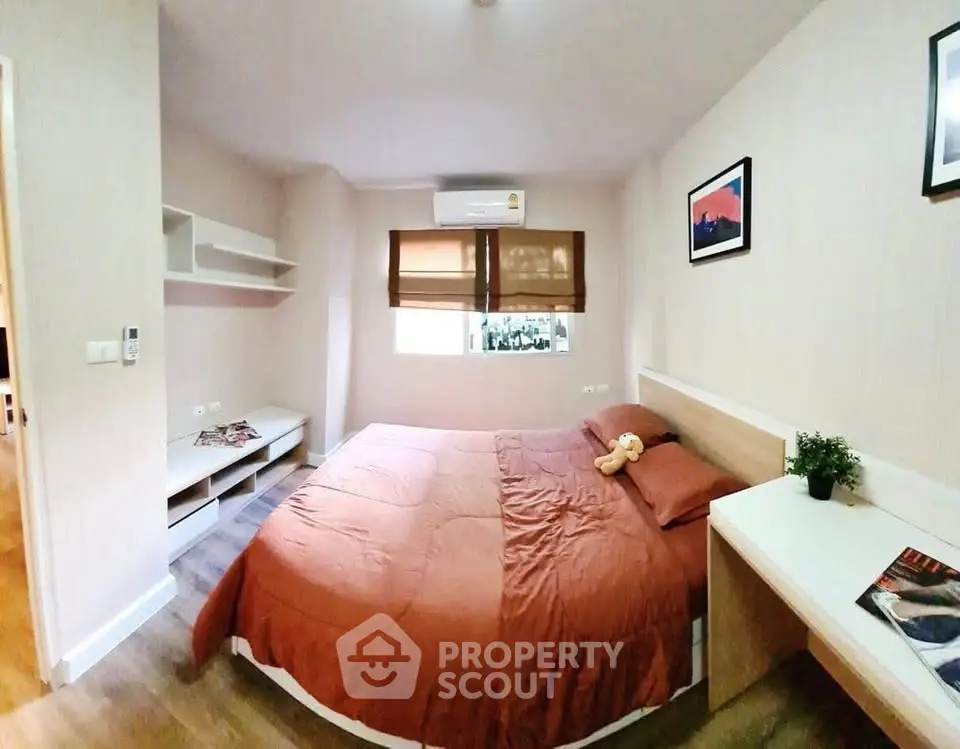 Cozy bedroom with modern decor and natural light, perfect for relaxation.