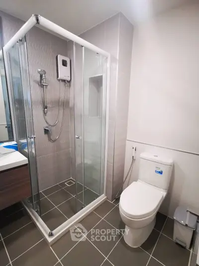 Modern bathroom with glass shower enclosure and sleek fixtures