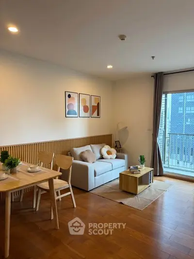 Modern living room with cozy decor and balcony view in stylish apartment.