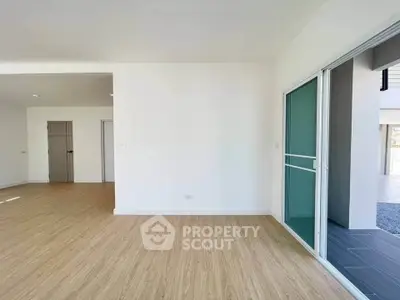 Spacious modern interior with sliding glass doors and wooden flooring