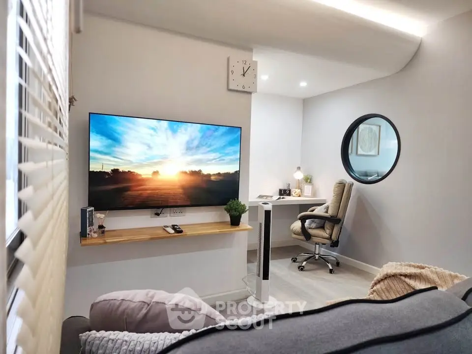 Modern living room with sleek TV setup and cozy study nook