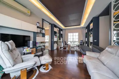 Spacious modern living room with elegant lighting and hardwood floors