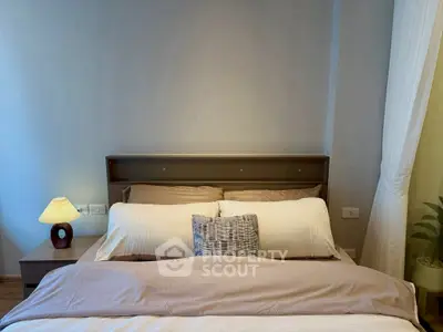 Cozy bedroom with modern decor and soft lighting, perfect for relaxation.