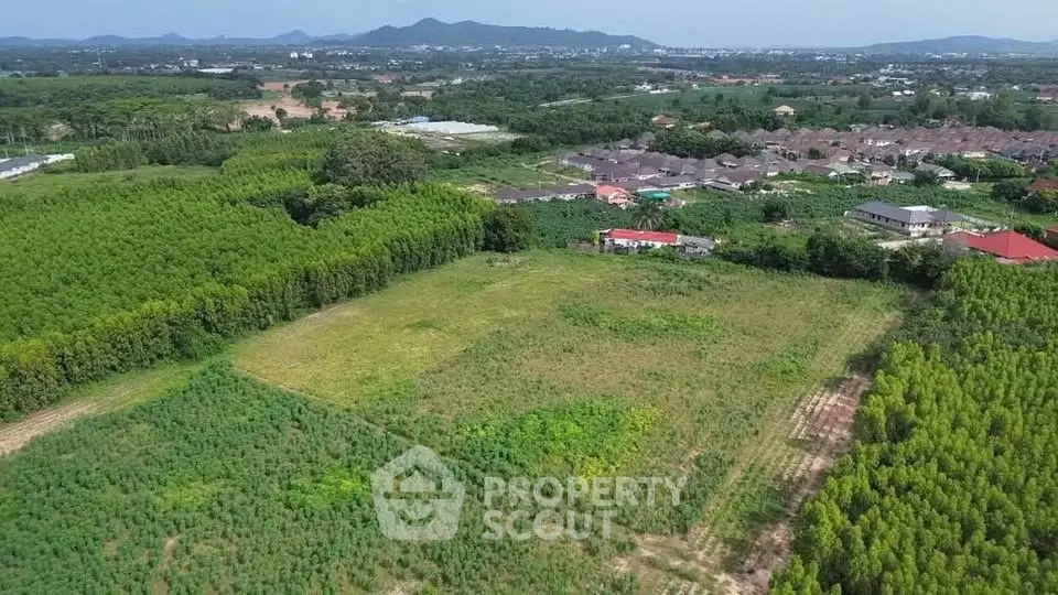 Expansive land plot with lush greenery and scenic mountain views, ideal for development opportunities.