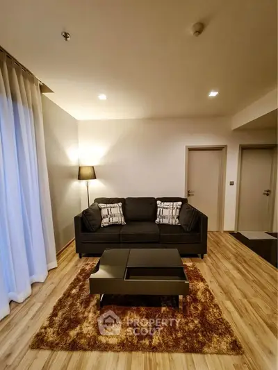 Modern living room with cozy sofa and stylish decor in a contemporary apartment.