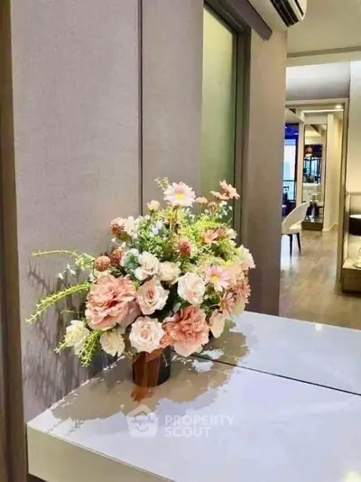 Elegant interior with floral arrangement and modern decor, showcasing a stylish living space.
