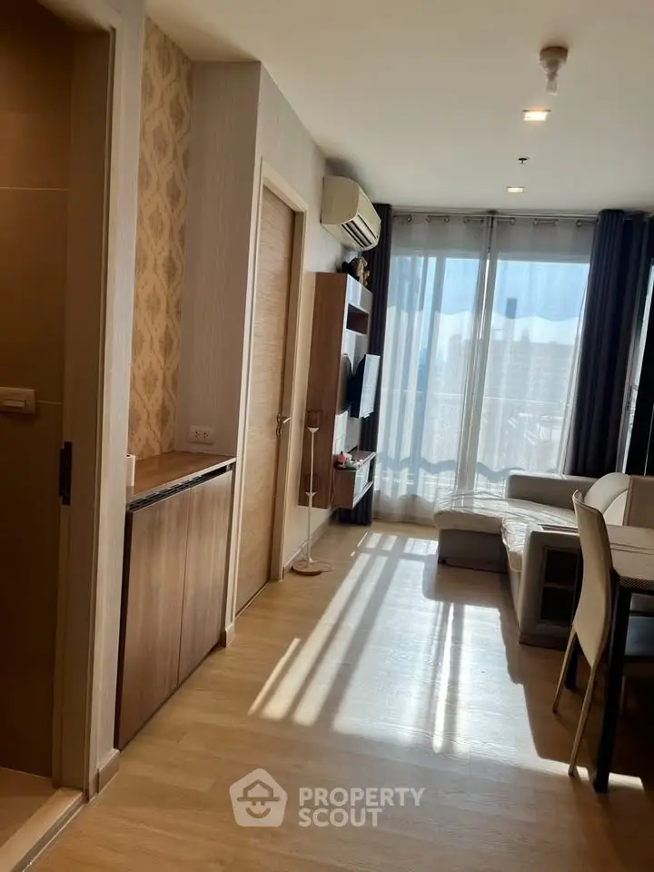 Bright and modern living room with large windows and stylish furniture in a contemporary apartment.