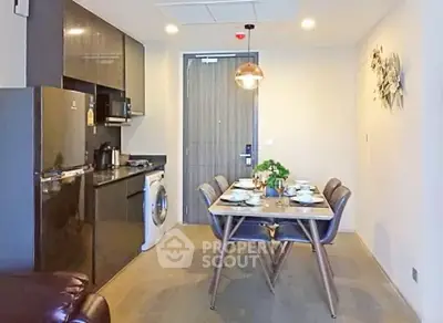 Modern kitchen and dining area with sleek appliances and stylish decor
