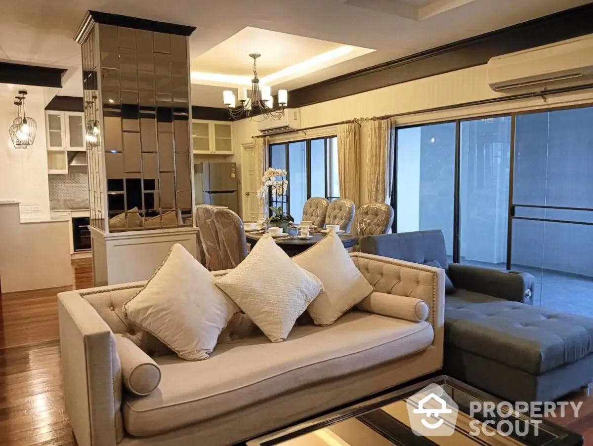 Luxurious living room with elegant dining area and modern kitchen in open layout apartment.