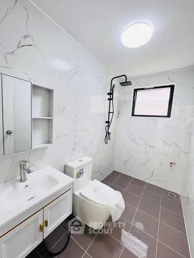 Modern bathroom with marble tiles and sleek fixtures