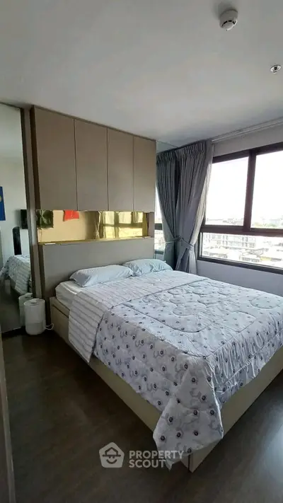 Modern bedroom with large window and stylish decor in urban apartment