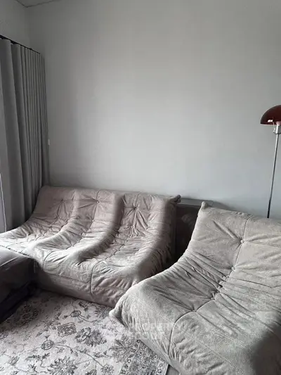 Cozy living room with plush sofas and elegant floor lamp