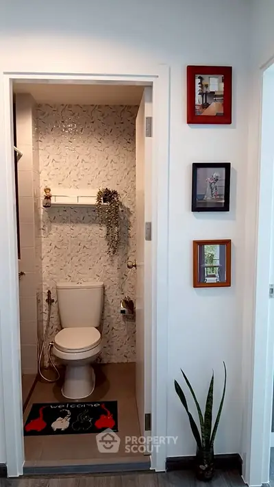 Modern compact bathroom with stylish decor and wall art