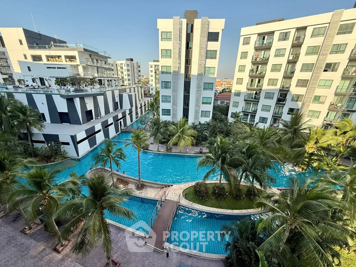 Luxurious residential complex with stunning pool and lush greenery