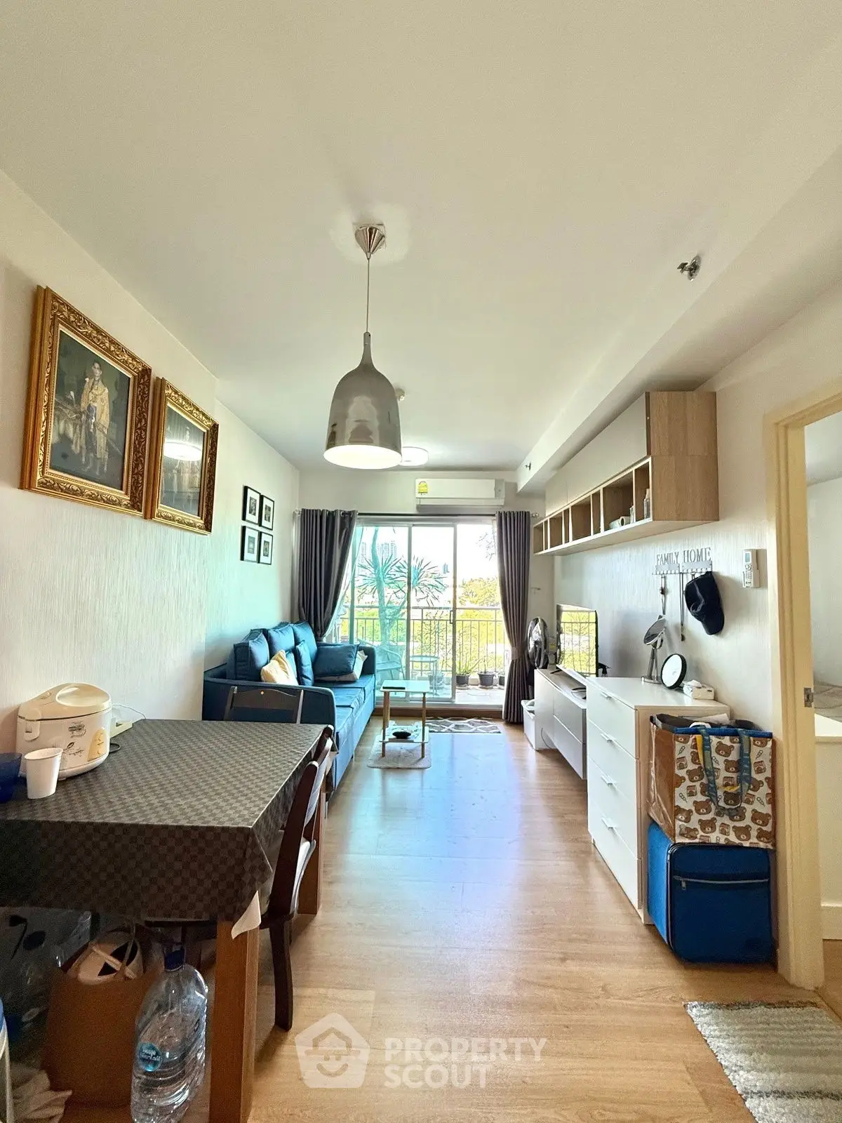 Charming living room with modern decor and balcony view, perfect for cozy living.