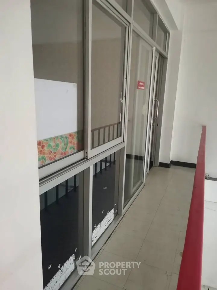 Modern apartment balcony with sliding glass doors and sleek railing design