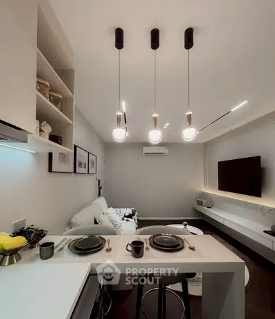Modern open layout living room with stylish lighting and sleek decor