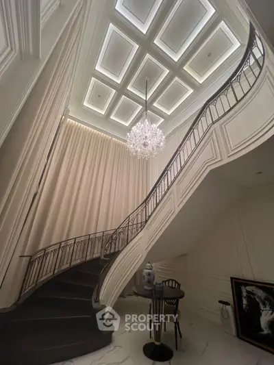 Luxurious staircase with elegant chandelier in upscale home interior