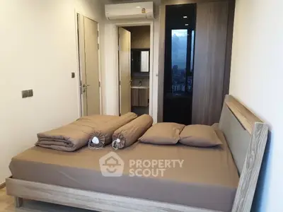Modern bedroom with ensuite bathroom and sleek wooden furnishings.