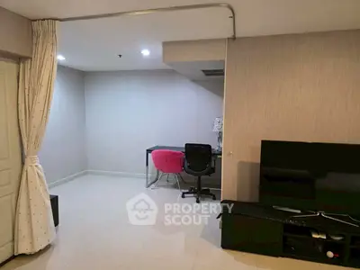 Modern living room with study area, featuring sleek furniture and neutral tones.