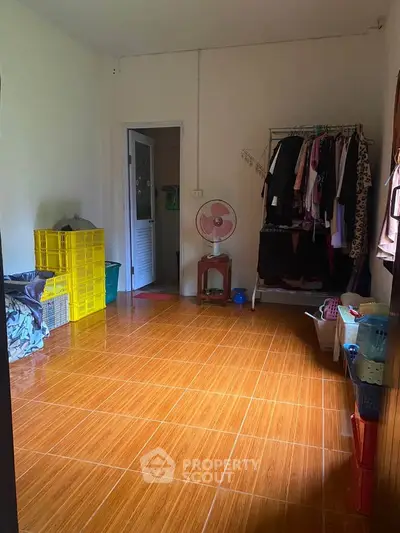 Spacious room with tiled flooring and ample storage space, perfect for versatile living arrangements.