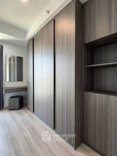 Spacious modern storage area with sleek wooden cabinetry and elegant design.