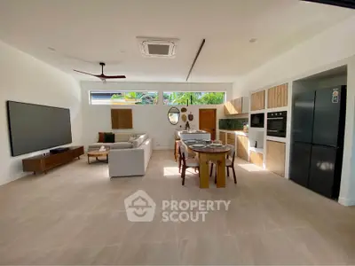 Spacious open-plan living room and kitchen with modern appliances and stylish decor.