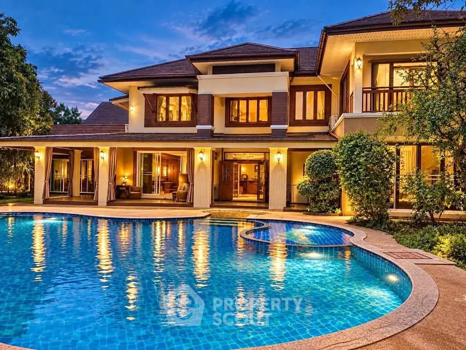 Luxurious villa with stunning pool and elegant exterior lighting at dusk.