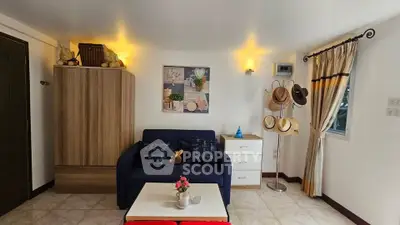 Charming living room with cozy sofa, stylish decor, and ample natural light, perfect for relaxation.