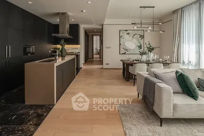 Luxurious open-plan living room and kitchen with modern decor and elegant dining area.