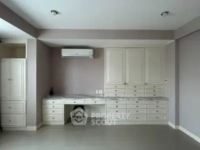 Spacious study room with built-in cabinets and air conditioning