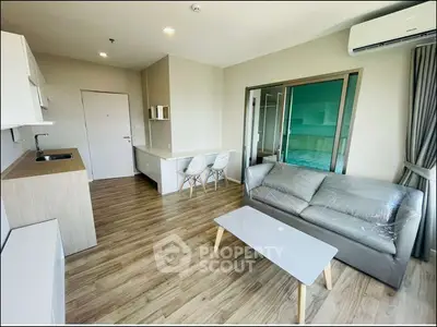 Modern open-plan living room with sleek kitchen and stylish furniture