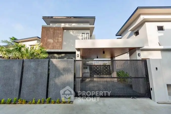 Modern luxury home exterior with sleek design and gated entrance