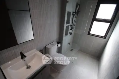 Modern bathroom with sleek fixtures and large window for natural light